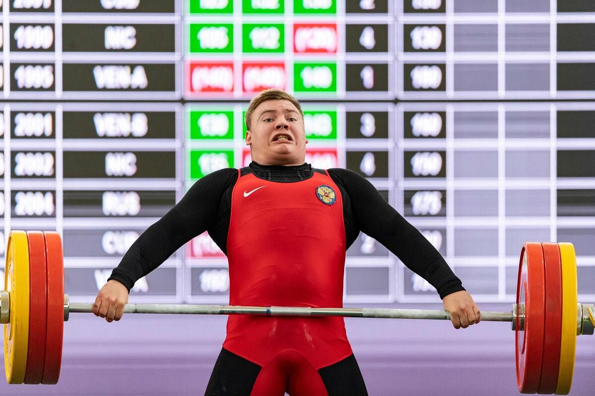 Russia's Dimitri Shmarin gestures while lifting the weight during the 96kg Snatch and Clean & Jerk weightlifting competition during 5th ALBA Games at the Army Military Academy Gym in Fuerte Tiuna, Caracas. Credit: AFP Photo