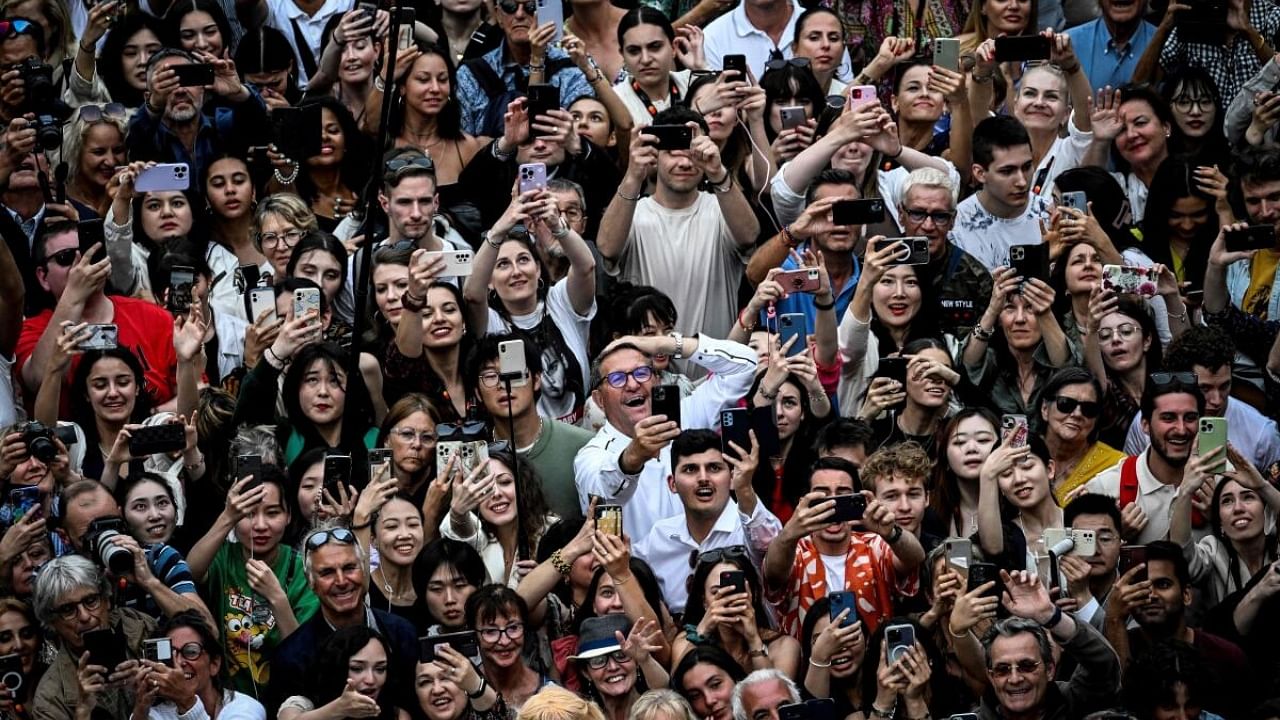 Members of the audience react during the opening ceremony and the screening of the film "Jeanne du Barry" during the 76th edition of the Cannes Film Festival in Cannes, southern France, on May 16, 2023. Credit: AFP Photo