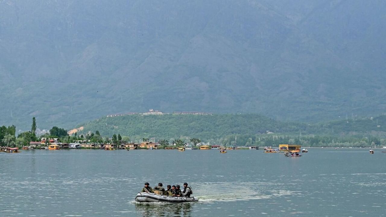 Indian Navy's Marine Commandos (MARCOS) patrol in Dal Lake in Srinagar on May 17, 2023, ahead of upcoming G20 meeting. Credit: AFP Photo