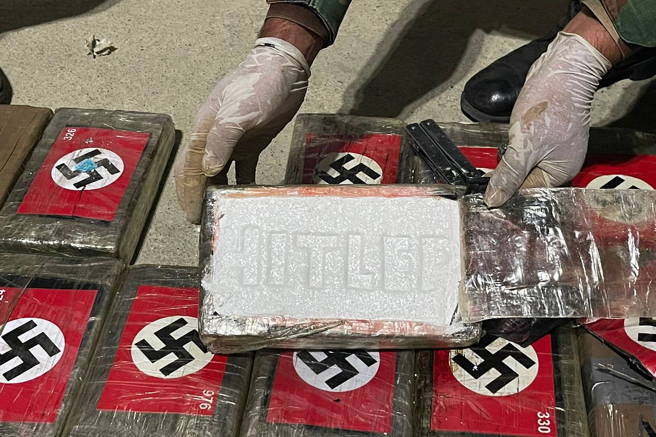 This handout picture released by the Peruvian National Police shows the police showing the 58 kilos of cocaine branded with the Nazi swastika and engraved with Hitler’s name seized in a Liberian-flagged container ship docked in the northern port of Paita, Peru, on May 25, 2023. Credit: AFP Photo