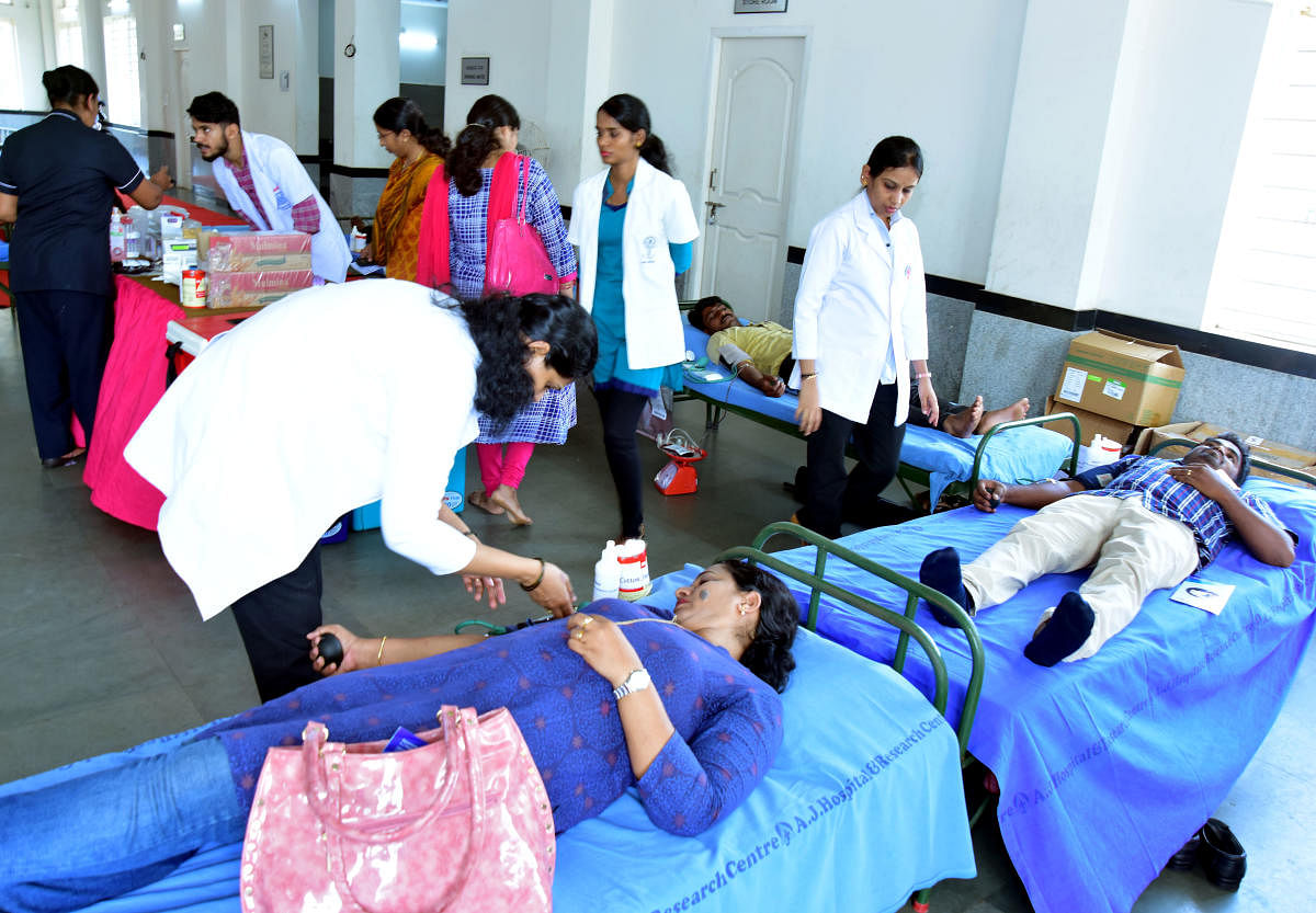 Members of Karnataka State Government NPS Employees’ Union Mangaluru unit donate blood at Mini Town Hall in Mangaluru on Wednesday, as a mark of their protest against the National Pension Scheme.